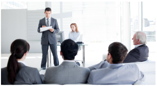 man giving briefing at front of room