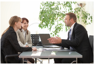 Three business people communicating at a table